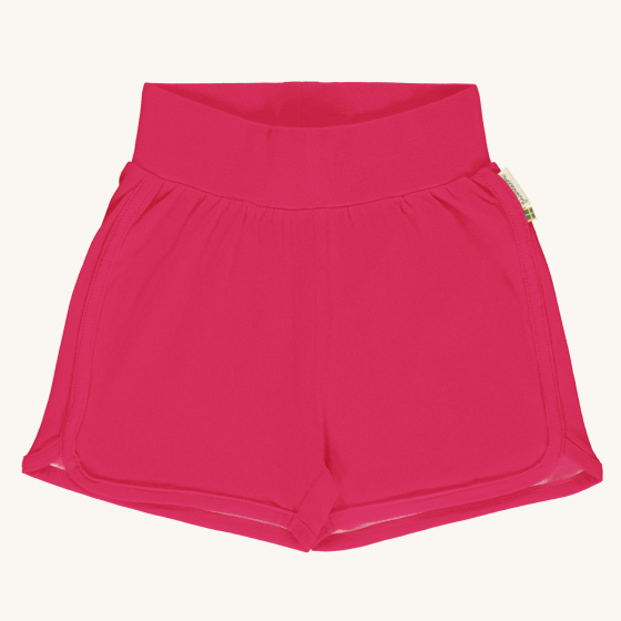 Maxomorra solid blossom pink colour organic cotton runner style shorts pictured on a plain coloured background