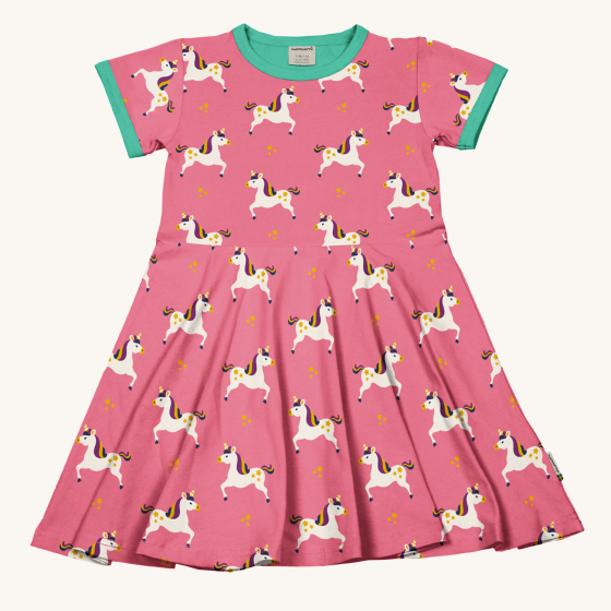 Maxomorra Unicorn Organic Cotton Children's Short Sleeve Circle Dress. A vibrant pink fabric dress with a fun unicorn print and green trim around the collar and sleeves