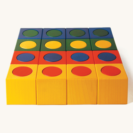 Naef precision manufactured wooden Ligno stacking shapes toy laid out in a square shape on a beige background
