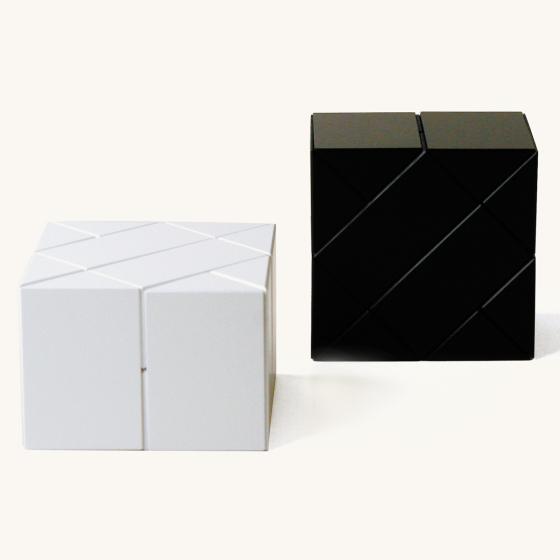 Naef black and white ponte premium wooden toy shapes stacked in 2 cubes on a beige background