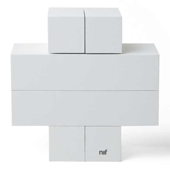4 identical pieces of Naef's Quadrigo wooden toy slotted together to make a cross shape on a white background.