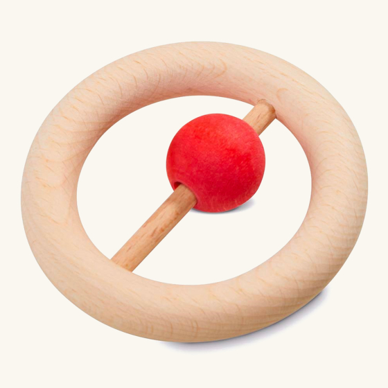 Nic plastic-free wooden baby rattle ring toy on a beige background