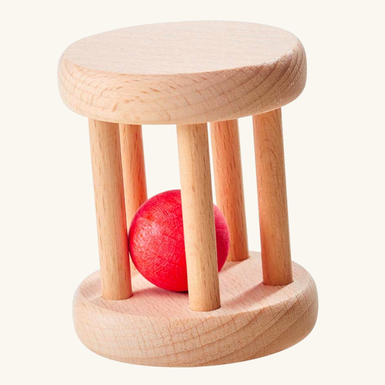 Nic plastic-free wooden baby ball roller toy on a beige background