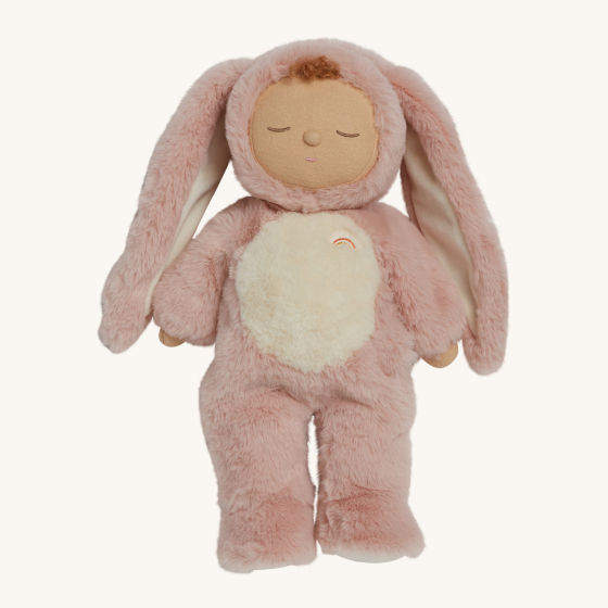 Olli Ella Cozy Dinkums Doll - Bunny Flopsy. A soft body doll, in a fluffy pink fur and a fluffy white belly none removable onesie. Bunny Flopsy has their eyes closed, long fluffy pink ears attatched to the hood of their onesie, and a little brown tuft of 