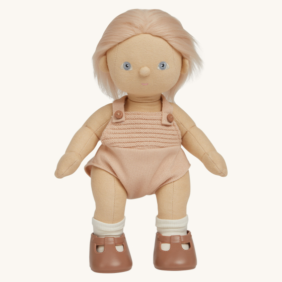 Olli Ella Petal poseable, soft bodied, light haired, Dinkum Doll standing up pictured on a plain coloured background 