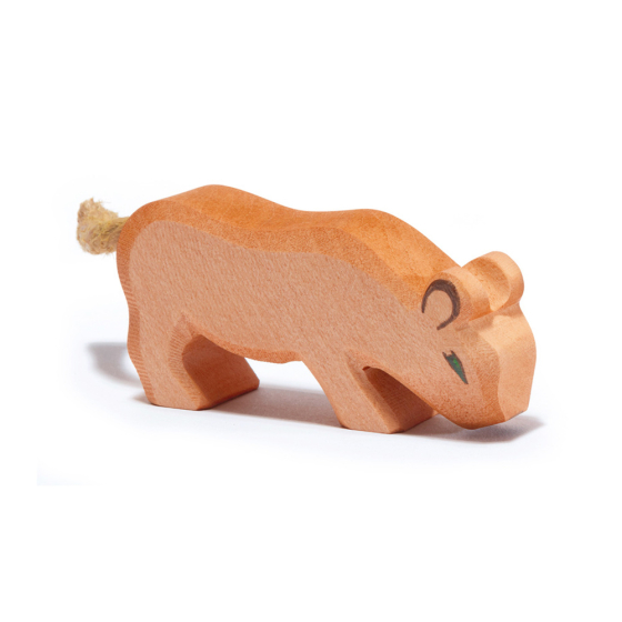 Ostheimer handmade childrens wooden lion cub toy with its head down on a white background