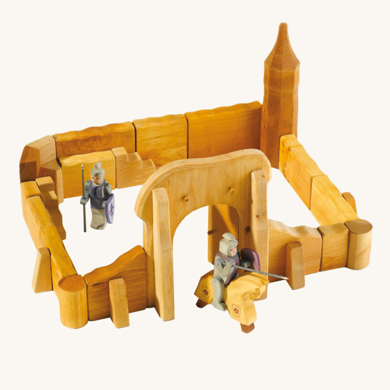 Ostheimer kids handmade wooden castle playset laid out on a beige background