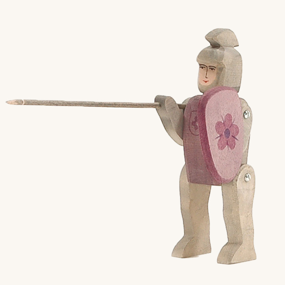 The Ostheimer Wooden Toy Red Riding Knight, handpainted with grey armour and a purple-red shield with a flower coat of arms. 