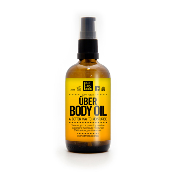 Our Tiny Bees Über Body Oil in bottle on white background