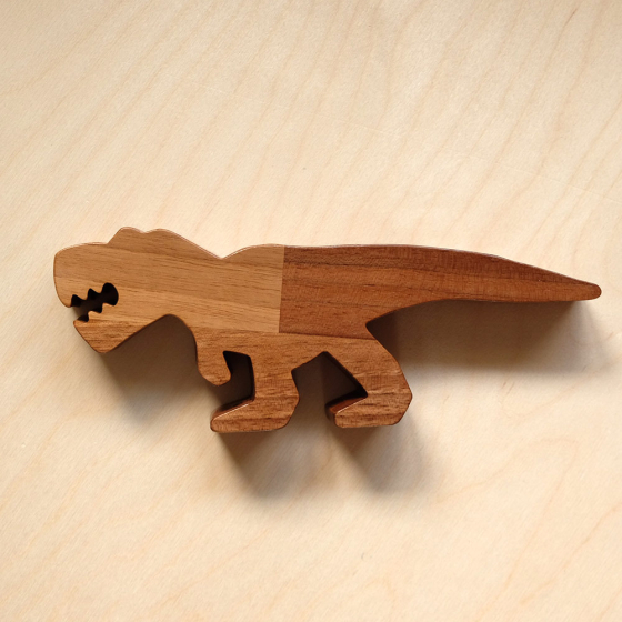 O-WOW eco-friendly Walnut T-Rex toy on a bright wooden background