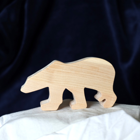 O-WOW handmade eco-friendly maple wood polar bear on a white sheet in front of a black background