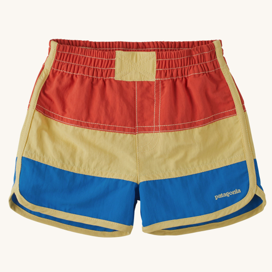 Patagonia Little Kids Boardshorts - Pimento Red. Shorts have red, sandy yellow and blue large stripes, with a sandy Patagonia logo on the bottom of the short leg