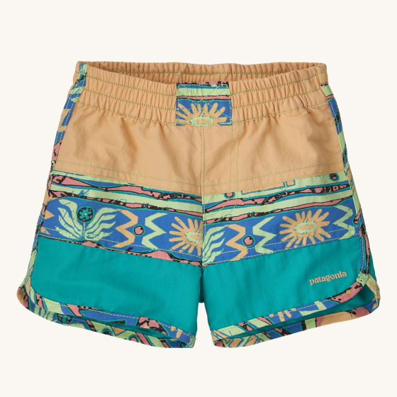 Patagonia Little Kids Boardshorts - Sandy Melon. The shorts have sandy yellow, light blue and Aztec print large stripes, with a sandy Patagonia logo on the bottom of the short leg