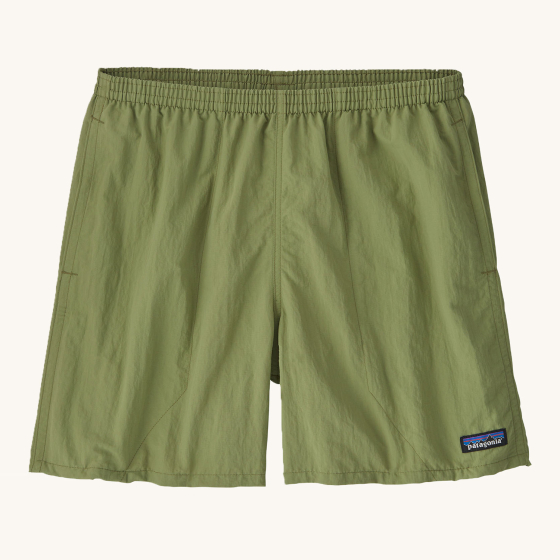 Patagonia Men's Baggies Beach Shorts - Buckhorn Green. Lightweight, multifunctional 100% recycled nylon Patagonia Baggies™ Shorts with a loose cut and longer leg, on a cream background