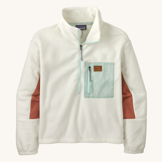 Patagonia Women's Microdini 1/2 Zip Fleece Pullover - Birch White with a light blue pocket and zips, a brown Patagonia logo on the pocket, and brown fleece material on the inside of the arms