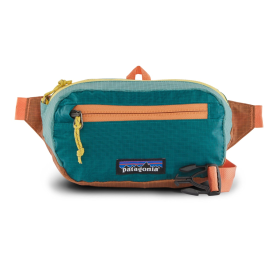 The Patagonia Ultralight Black Hole Mini Hip Pack - Patchwork: Current Blue, stood upright on a white background