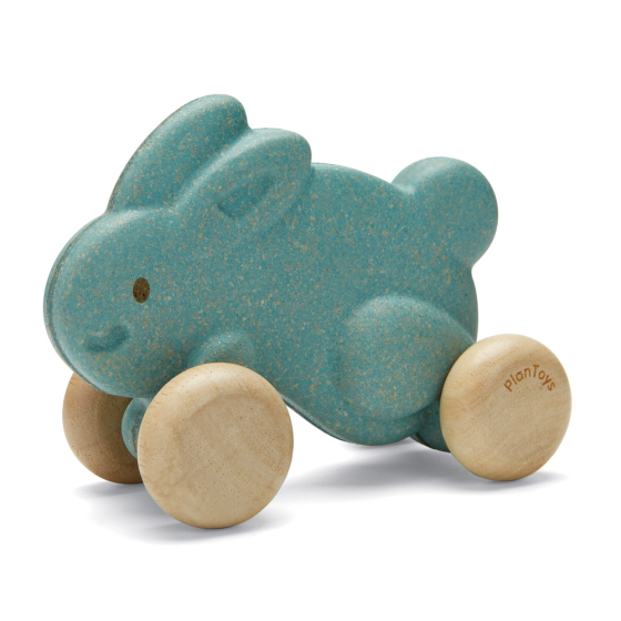 Plan Toys eco-friendly wooden push along bunny toy in blue on a white background