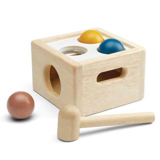 PlanToys children's plastic-free wooden punch and drop ball toy in the orchard colours on a white background