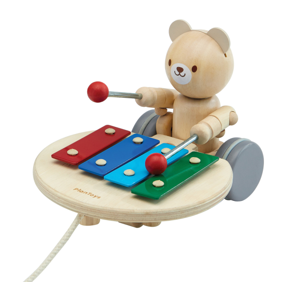 PlanToys wooden musical pull along bear toy on a white background