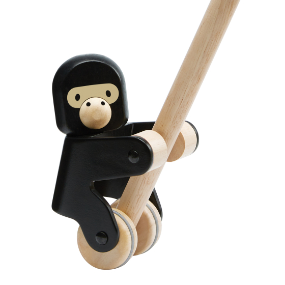 Close up of the PlanToys pull along climbing gorilla toy on a white background