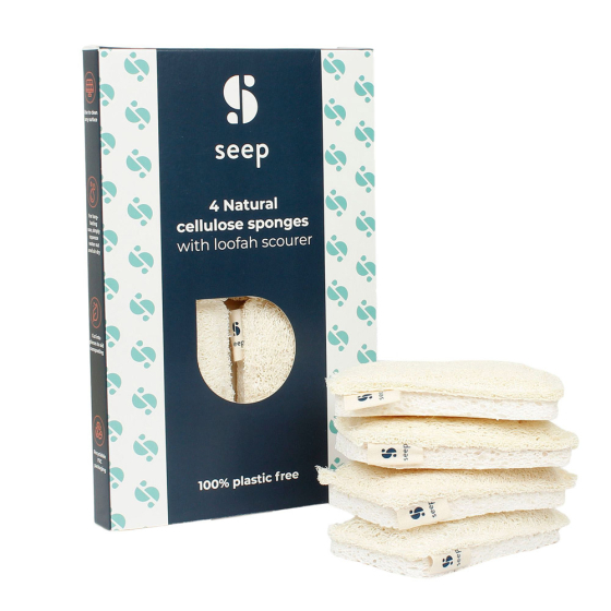 4 Seep natural cellulose and loofah scourers stacked in a pile next to their packaging on a white background