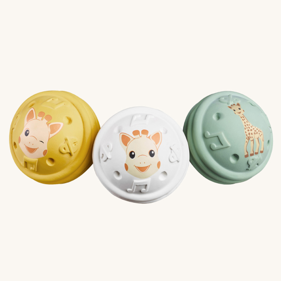 Sophie The Giraffe - Once Upon A Time 5 Senses Musical Balls. 3 natural rubber musical in different colours, yellow, white and mint green. On a cream background