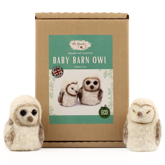 The Makerss Needle Felt Baby Barn Owl. Two beautifully crafted white and light brown baby barn owls, one with its eyes open and the other closed, stood next to their box