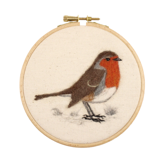 The Makerss 2D RSPB Robin Needle Felting Kit. A 2D needle felting craft of a brown Robin and red chest, in a crafting hoop on beige fabric