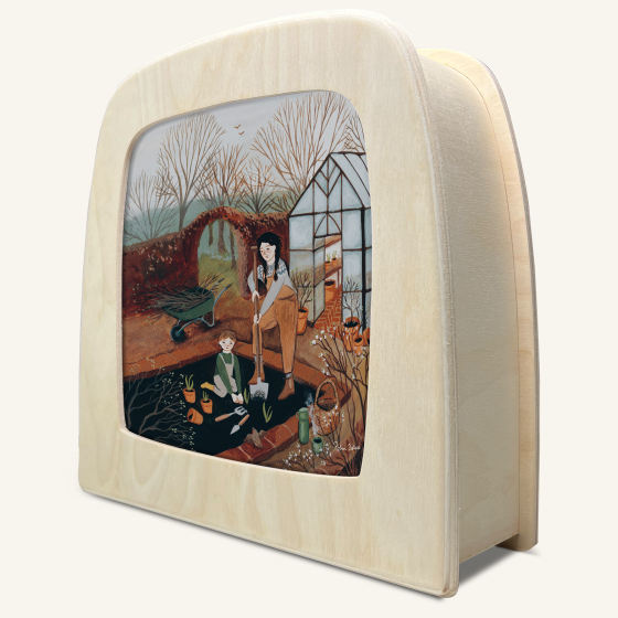 wooden lamp with a picture slide inserted. Slide shows child helping mother in the garden.