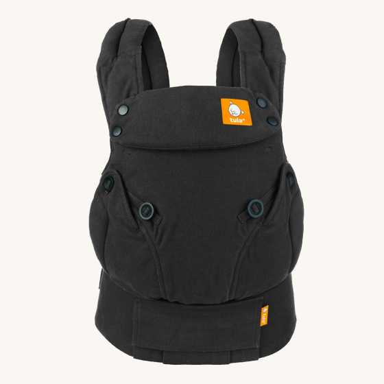 Tula Explore hemp baby carrier in the obsidian grey colour on a beige background