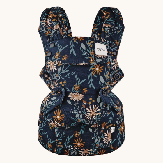 Tula Explore baby carrier in Lush Field print showing flower patterns on navy blue 
