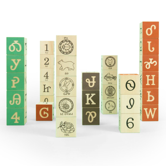 Uncle Goose Cherokee language wooden toy blocks stacked in towers on a white background