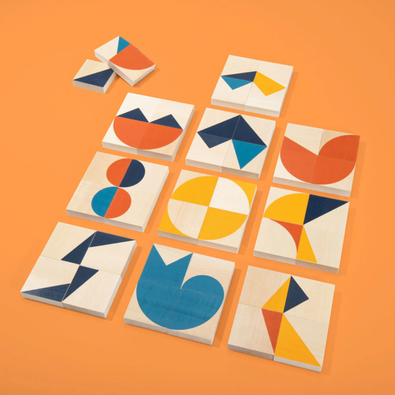 Uncle Goose kids handmade wooden mod pattern blocks laid out in a colourful pattern on an orange background