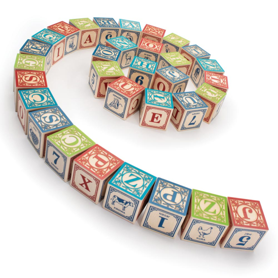 Uncle Goose eco-friendly wooden polish language blocks laid out in a spiral on a white background