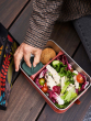 Person wearing a tweed jacket having lunch from the Klean Kanteen Rise Stainless Steel Big Meal Box with divider