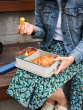 Person wearing a denim jacket having lunch from the Klean Kanteen Rise Stainless Steel Big Meal Box with divider