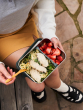 Klean Kanteen Rise Stainless Steel Meal Box with divider at 1/3 holding a salad in one section and strawberries in the other