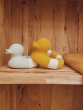 Yellow and mint coloured Oli & Carol Flo The Floatie Ducks placed on a wooden shelving unit 