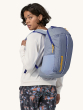 Person wearing the Patagonia Recycled Black Hole Backpack 25L in Pale Periwinkle, rear side view, on a cream background
