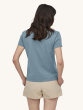 A person wearing a blue/grey Patagonia Women's Regenerative Organic T-Shirt, and light cream shorts ona  cream background