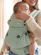 A baby is happily sat up in the Tula Explore Carrier, facing parent. Parent is holding the back of the babies head
